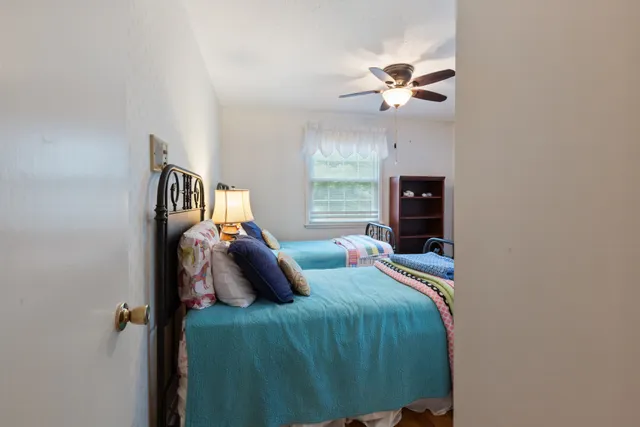 a bedroom with two beds and a window