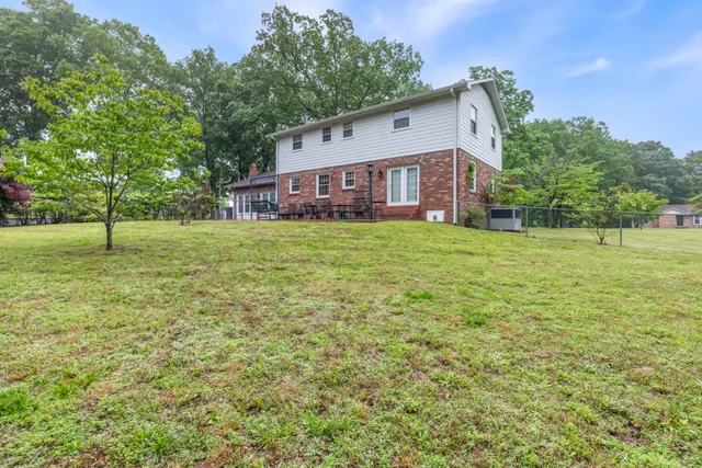 a view of a field of grass and trees