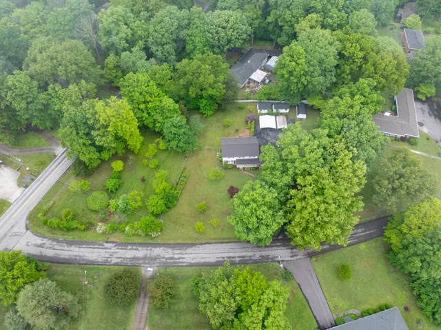 an aerial view of a house with yard