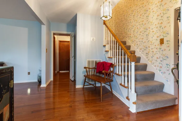 a view of entryway and hall with wooden floor