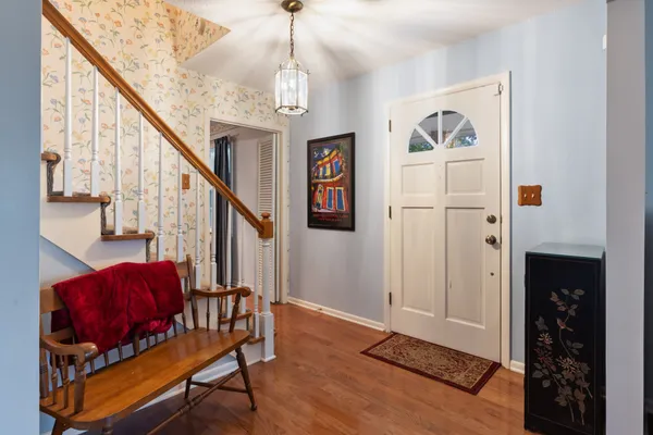 a living room with furniture or couch and a chandelier
