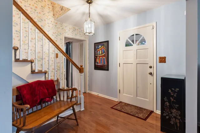a living room with furniture or couch and a chandelier