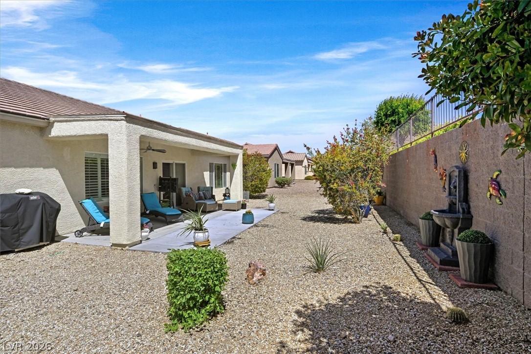 2228 Waterton Rivers Drive Henderson, NV 89044 - Photo 44 of 57 Covered Patio with Ceiling Fan and extended patio.