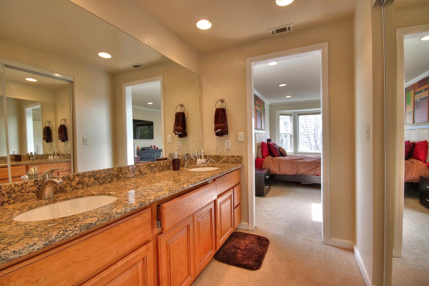 761 Superior Road Milpitas, CA 95035 - Photo 18 of 41 a en suite bathroom with a granite countertop double vanity sink and a mirror