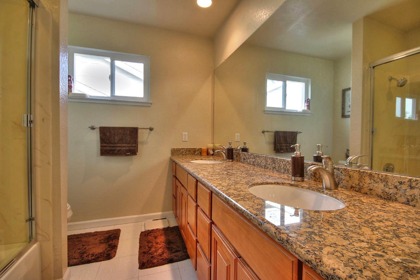 761 Superior Road Milpitas, CA 95035 - Photo 22 of 41 a bathroom with a granite countertop sink a mirror and a