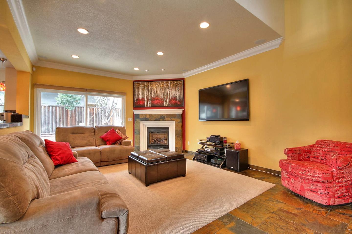 761 Superior Road Milpitas, CA 95035 - Photo 24 of 41 a living room with furniture a flat screen tv and a fireplace