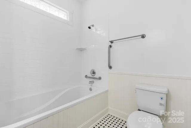 a bathroom with a bathtub and a toilet