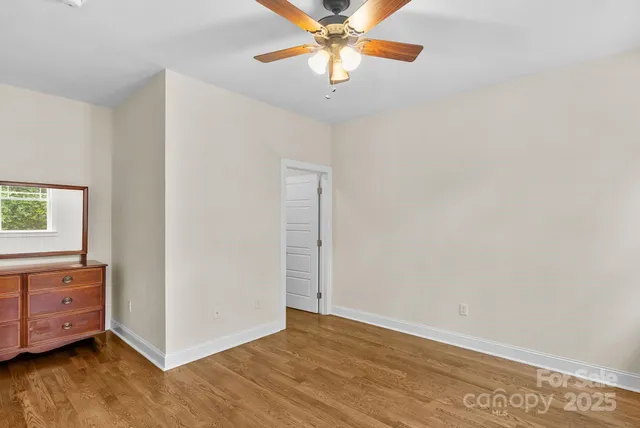 a view of room with window and a ceiling fan
