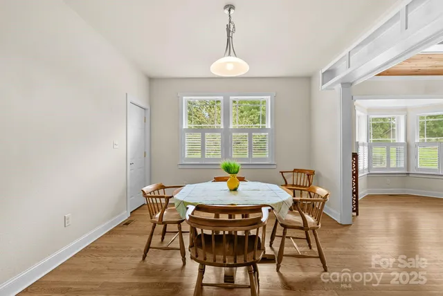 a view of a dining room with furniture window and wooden floor