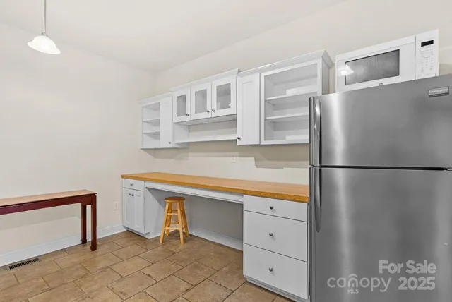 a kitchen with stainless steel appliances a refrigerator and a stove