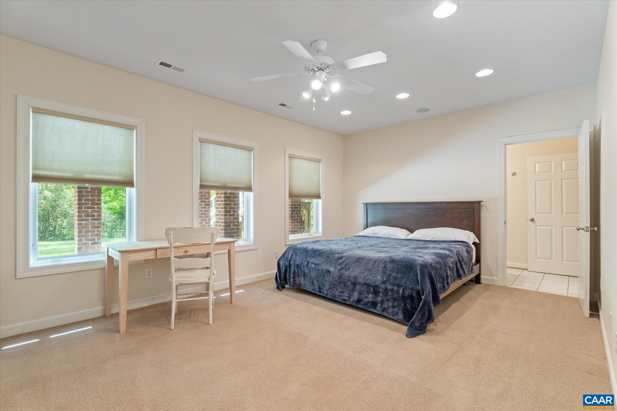 1698 Broken Island Road Palmyra, VA 22963 - Photo 55 of 74 a spacious bedroom with a large bed and a table chair