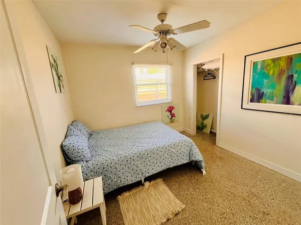 a bedroom with a bed and a window