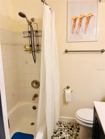 a bathroom with a shower a toilet and a sink