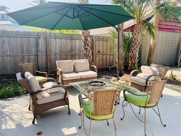 a backyard view with a seating space