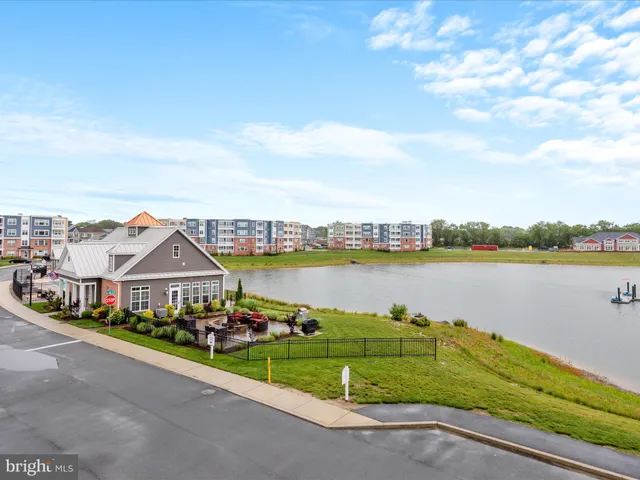 a kitchen with stainless steel appliances granite countertop a refrigerator a sink a stove a microwave and island