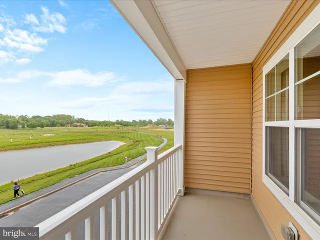 a view of an empty room and wooden floor