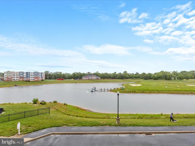 a living room with furniture a flat screen tv and a large window