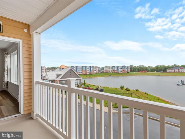 a view of a dining room with furniture a kitchen and chandelier