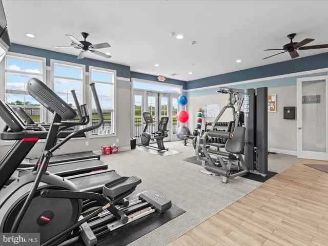 a sign board with a big yard and large trees