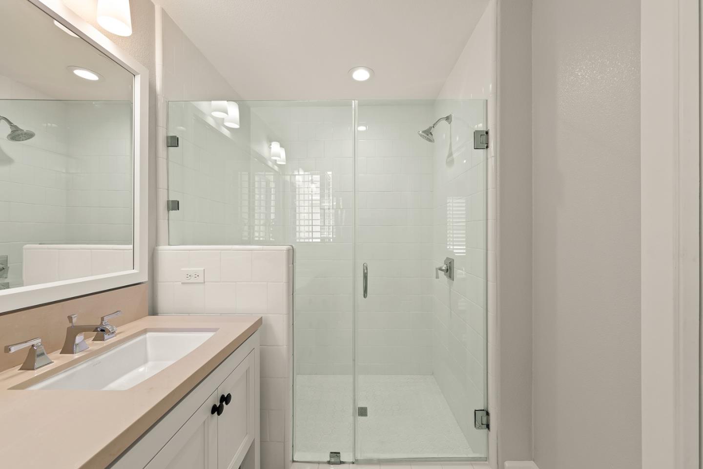 425 Robin Ridge Way Campbell, CA 95008 - Photo 36 of 46 a bathroom with a shower sink vanity and mirror