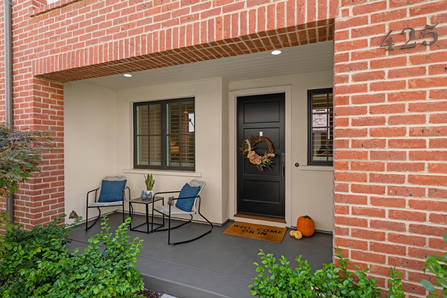 425 Robin Ridge Way Campbell, CA 95008 - Photo 46 of 46 a view of a patio with a table and chairs and potted plants next to a brick wall