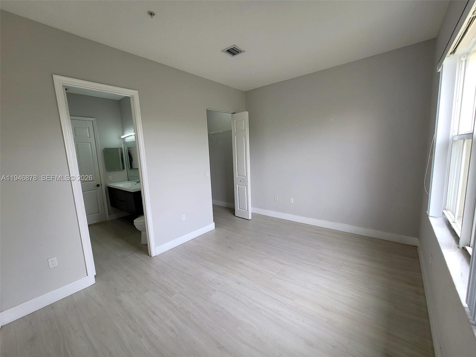 4602 Southwest 160th Avenue, Unit 536 Miramar, FL 33027 - Photo 13 of 30 an empty room with windows and entrance