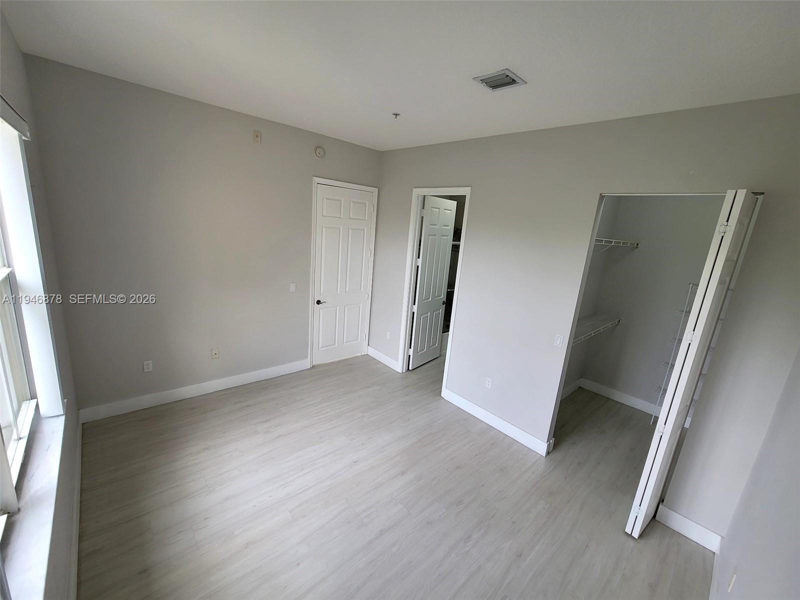 4602 Southwest 160th Avenue, Unit 536 Miramar, FL 33027 - Photo 14 of 30 an empty room with wooden floor and entrance