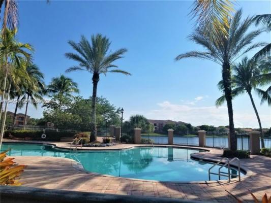 4602 Southwest 160th Avenue, Unit 536 Miramar, FL 33027 - Photo 22 of 30 a view of a swimming pool with a table and chairs