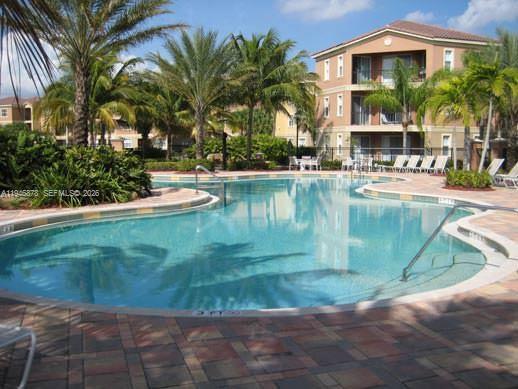 4602 Southwest 160th Avenue, Unit 536 Miramar, FL 33027 - Photo 23 of 30 a view of a swimming pool with a patio