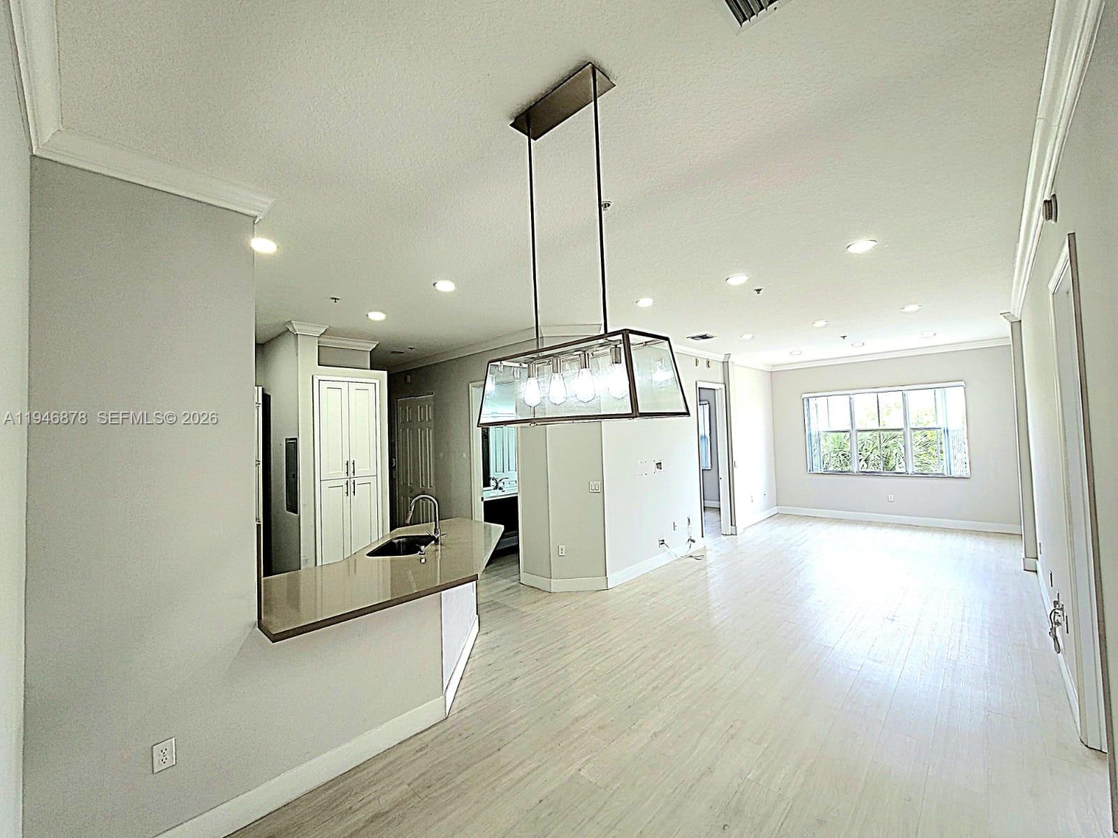 4602 Southwest 160th Avenue, Unit 536 Miramar, FL 33027 - Photo 3 of 30 a view of a big room with wooden floor and windows