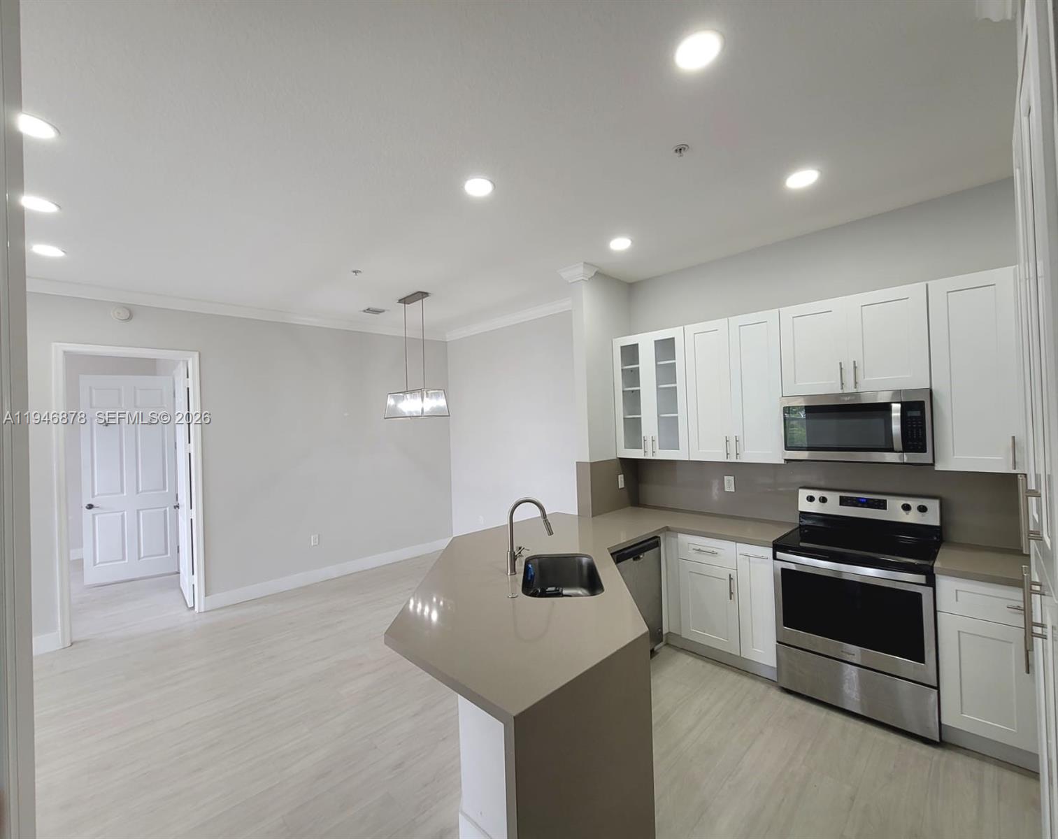 4602 Southwest 160th Avenue, Unit 536 Miramar, FL 33027 - Photo 6 of 30 a kitchen with kitchen island a sink stainless steel appliances and cabinets