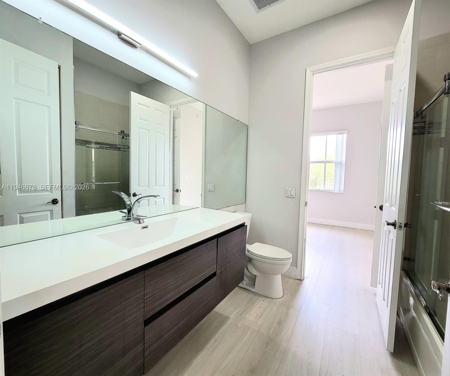 4602 Southwest 160th Avenue, Unit 536 Miramar, FL 33027 - Photo 10 of 30 a bathroom with a double vanity sink toilet and mirror