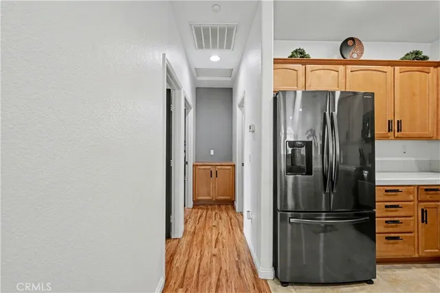 a kitchen with a refrigerator and cabinets
