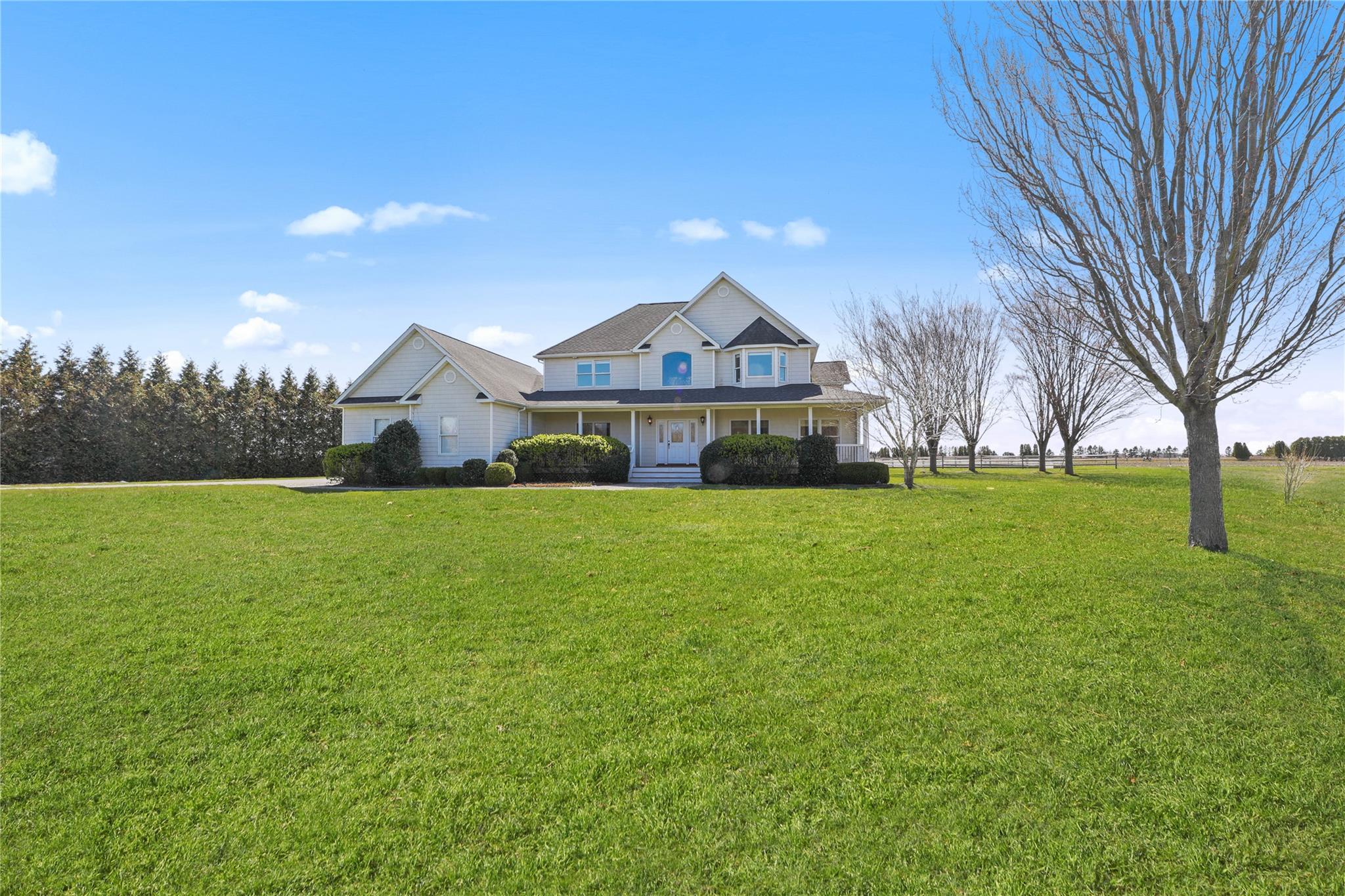 703 Herricks Lane Riverhead, NY 11901 - Photo 1 of 1 View of front facade with a front lawn