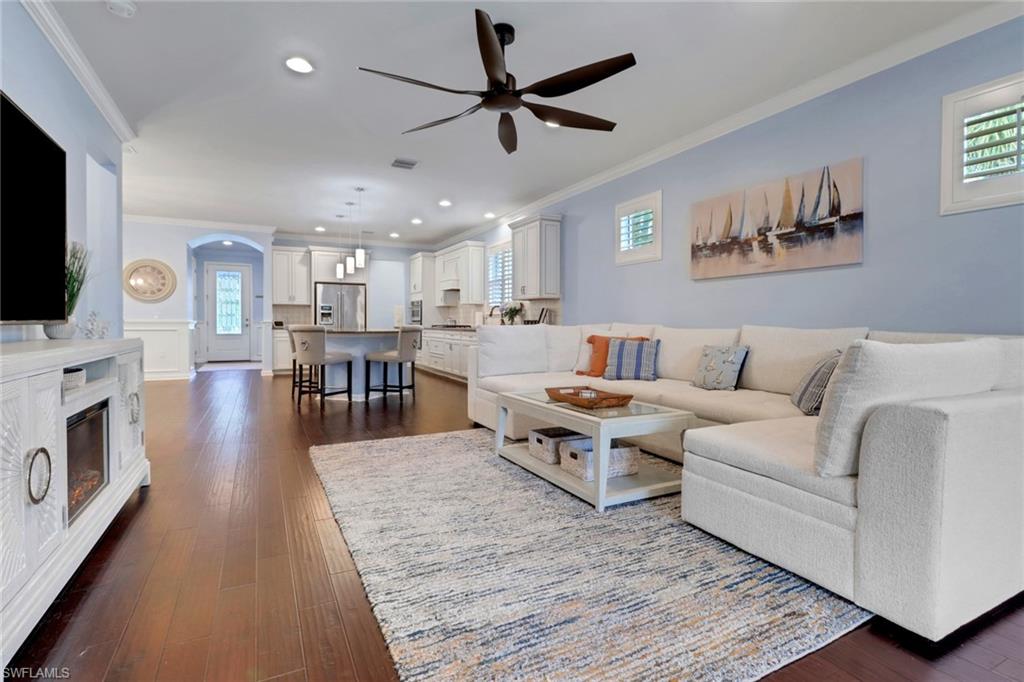 10588 Jackson Square Drive Estero, FL 33928 - Photo 15 of 50 a living room with furniture a flat screen tv and a fireplace