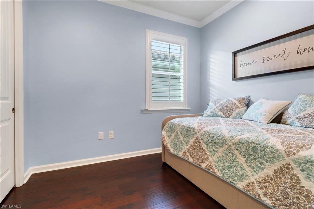 10588 Jackson Square Drive Estero, FL 33928 - Photo 24 of 50 a bed sitting in a bedroom next to a window