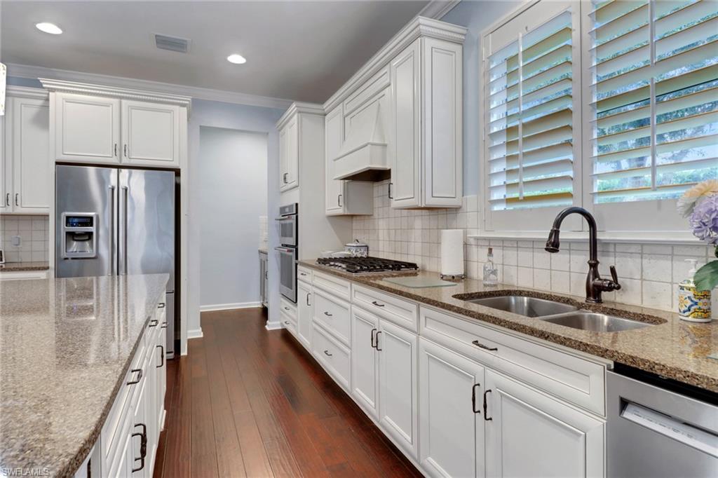 10588 Jackson Square Drive Estero, FL 33928 - Photo 9 of 50 a kitchen with granite countertop a sink stainless steel appliances and cabinets
