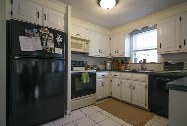 400 Stow Road Boxborough, MA 01719 - Photo 11 of 22 a kitchen with stainless steel appliances granite countertop a refrigerator a stove a sink and dishwasher with a dining table