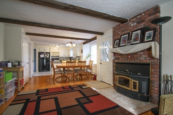 400 Stow Road Boxborough, MA 01719 - Photo 13 of 22 a living room with furniture a flat screen tv and a fireplace