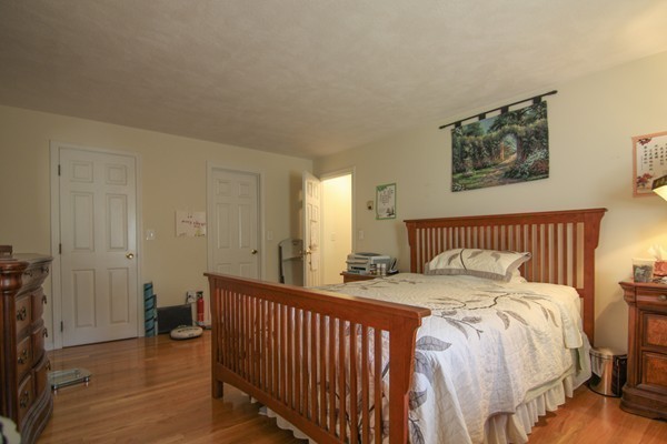 400 Stow Road Boxborough, MA 01719 - Photo 16 of 22 a bedroom with a bed and a table
