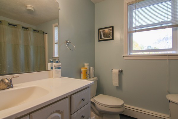400 Stow Road Boxborough, MA 01719 - Photo 19 of 22 a bathroom with a sink a toilet and a mirror
