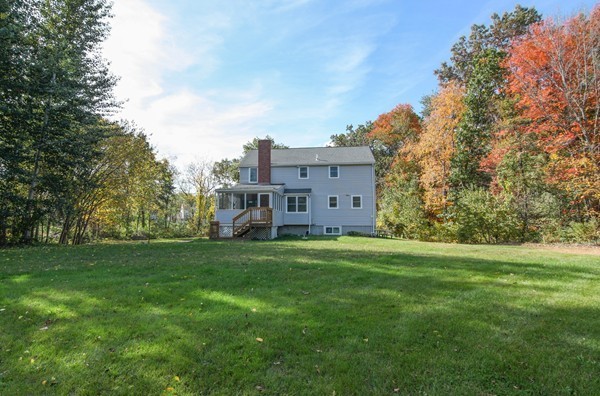 400 Stow Road Boxborough, MA 01719 - Photo 4 of 22 a view of a big house with a big yard and large trees