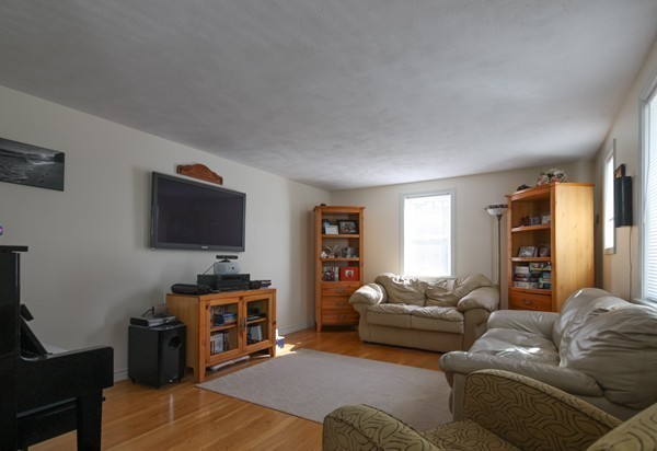 400 Stow Road Boxborough, MA 01719 - Photo 7 of 22 a living room with furniture and a flat screen tv