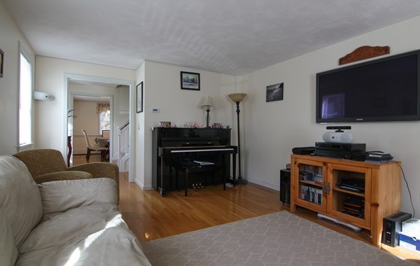400 Stow Road Boxborough, MA 01719 - Photo 9 of 22 a living room with furniture and a flat screen tv