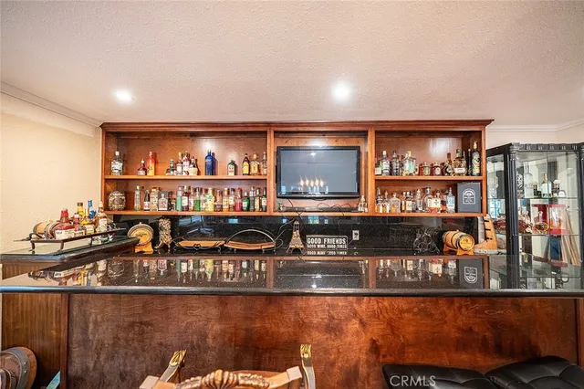 a bedroom with fireplace flat screen tv and window
