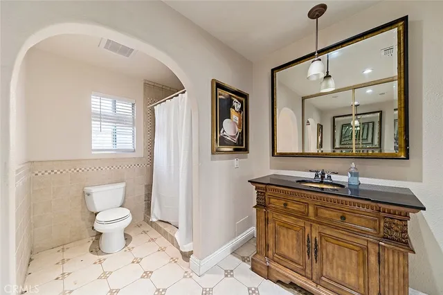 a bathroom with a toilet sink and vanity