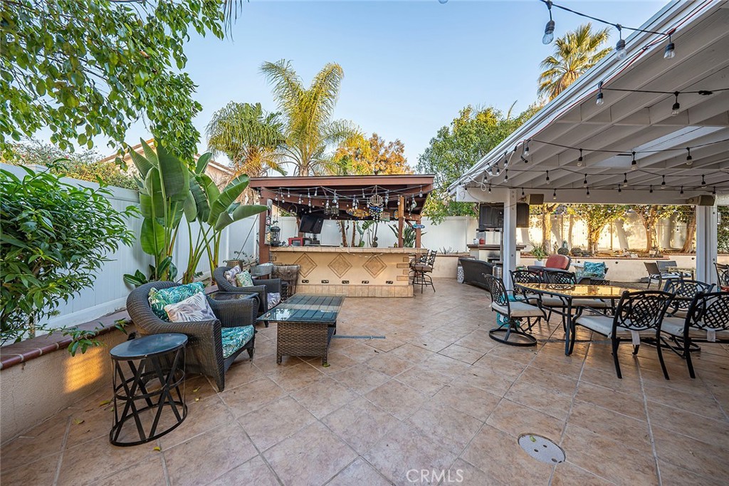 1704 Pass And Covina Road West Covina, CA 91792 - Photo 24 of 29 a view of a patio with table and chairs potted plants with wooden floor and fence
