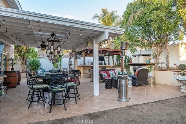 a view of a patio with table and chairs and potted plants