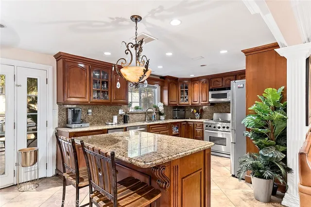 a dining room with furniture potted plants and wooden floor