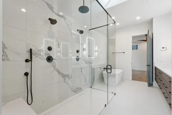 a bathroom with a shower and a mirror